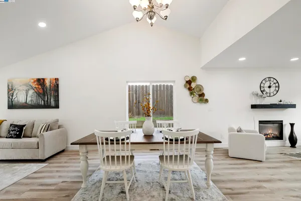 a living room with kitchen island furniture and a view of kitchen