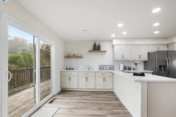 a kitchen with stainless steel appliances a refrigerator sink and cabinets