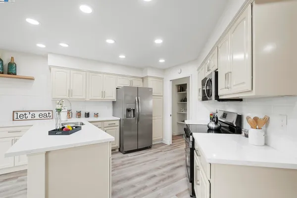 a kitchen with stainless steel appliances a stove a microwave and cabinets