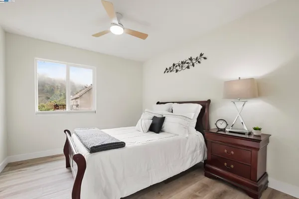 a bedroom with a bed and a lamp