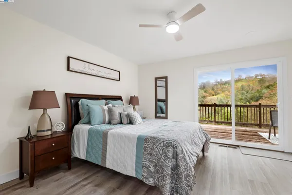 a bedroom with a bed and a painting on the wall