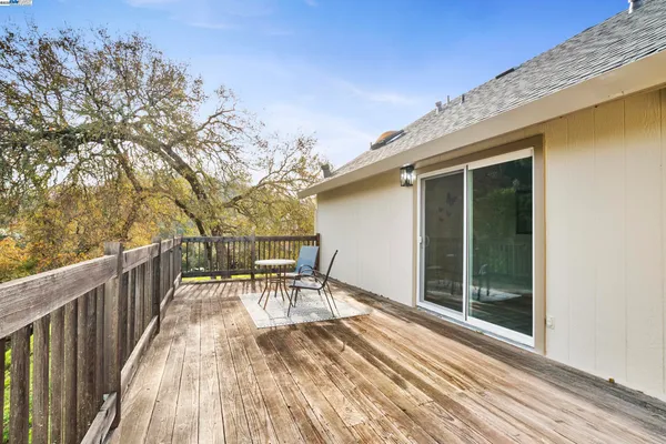 a view of a house with a wooden deck
