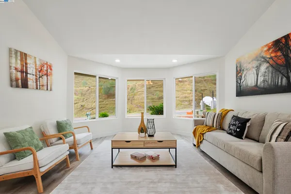 a living room with furniture and kitchen view