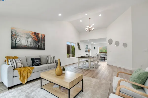 a living room with fireplace furniture and a wooden floor