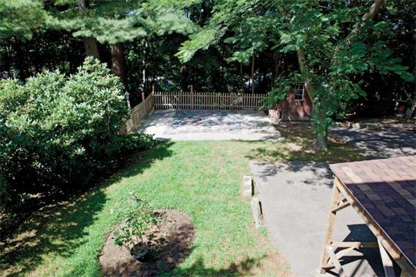 51 Wolcott Road Brookline, MA 02467 - Photo 7 of 7 a view of a garden with a fountain