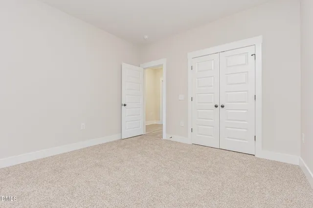 a bathroom with a granite countertop toilet sink and mirror