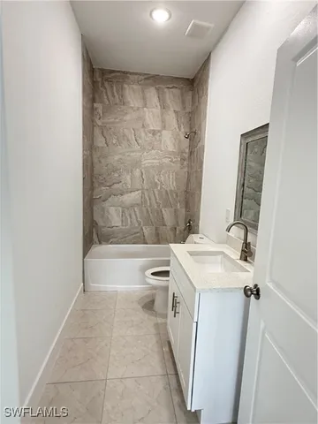 a bathroom with a sink a toilet and bathtub