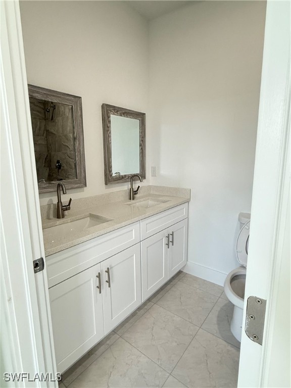 1015 Jaguar Boulevard Lehigh Acres, FL 33974 - Photo 7 of 9 a spacious bathroom with 2 sink and a mirror