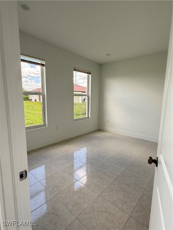 1015 Jaguar Boulevard Lehigh Acres, FL 33974 - Photo 9 of 9 an empty room with windows