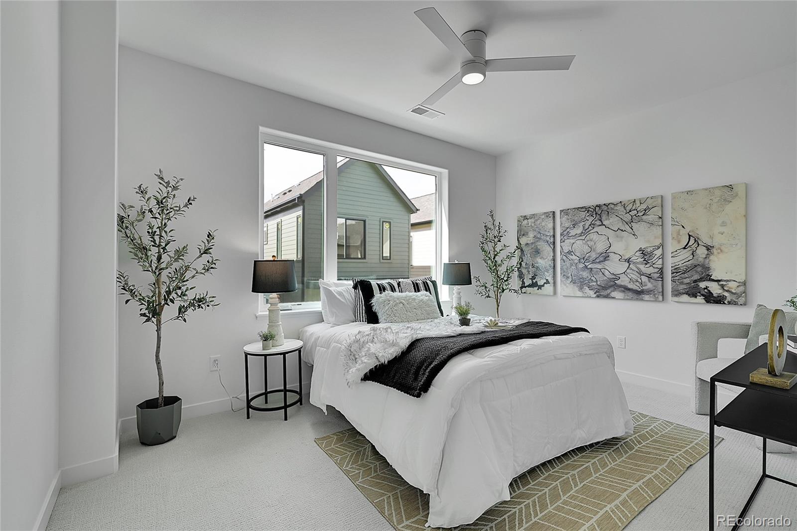 765 East County Line Road Erie, CO 80516 - Photo 17 of 28 a bedroom with a large bed and a potted plant