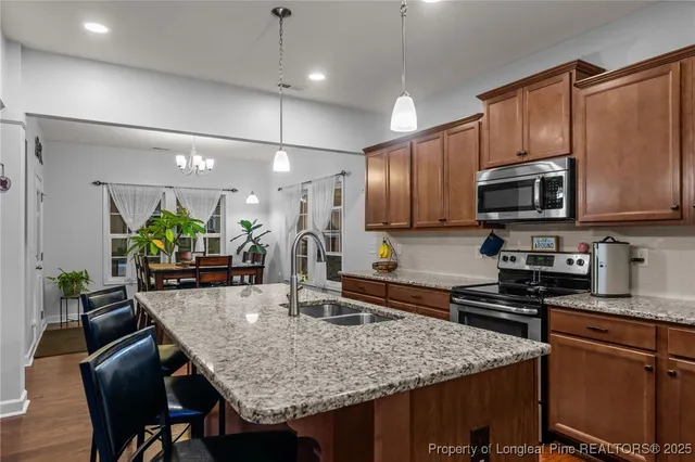 a kitchen with stainless steel appliances granite countertop a sink refrigerator and microwave