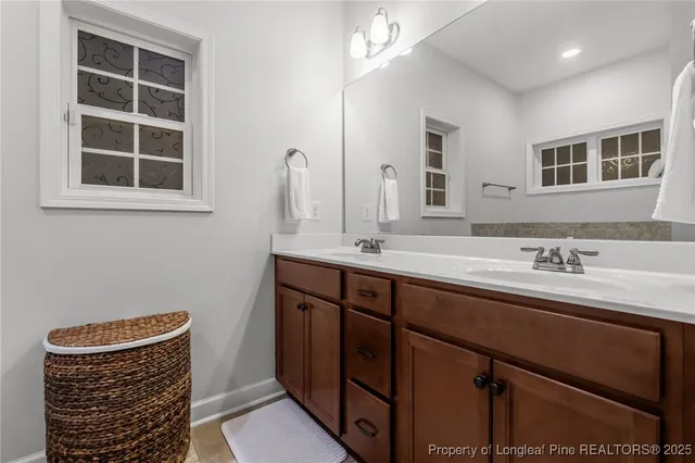 a bathroom with a sink a vanity and a mirror