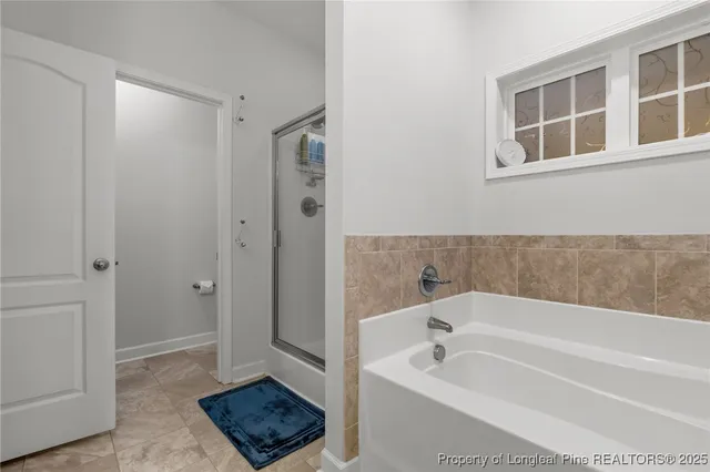 a bathroom with a tub a sink and a mirror