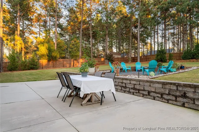 a view of a patio with chairs and potted plants