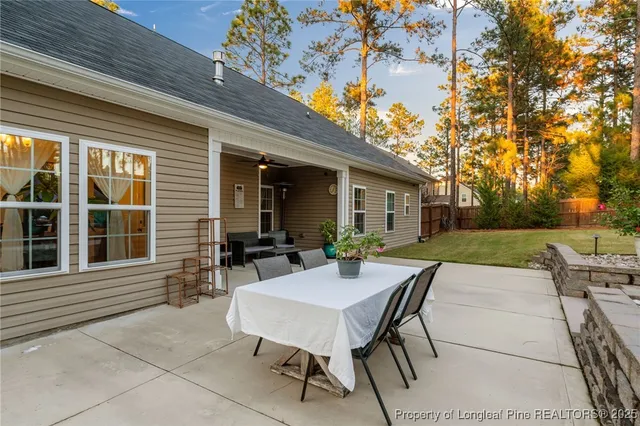 a view of a chairs and table in a backyard