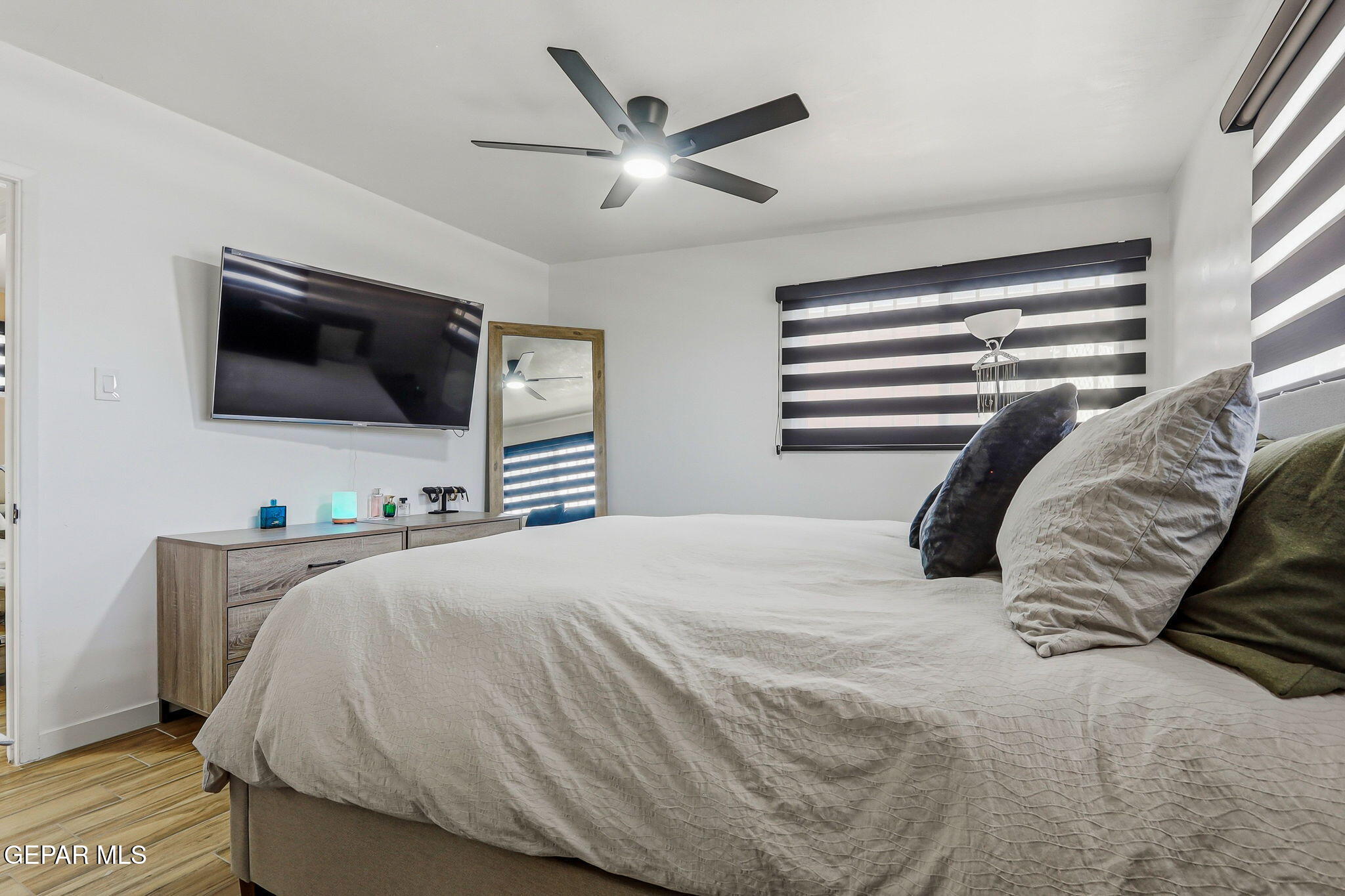 5240 Blue Ridge Drive El Paso, TX 79904 - Photo 22 of 37 a bedroom with a bed a flat screen tv and a window