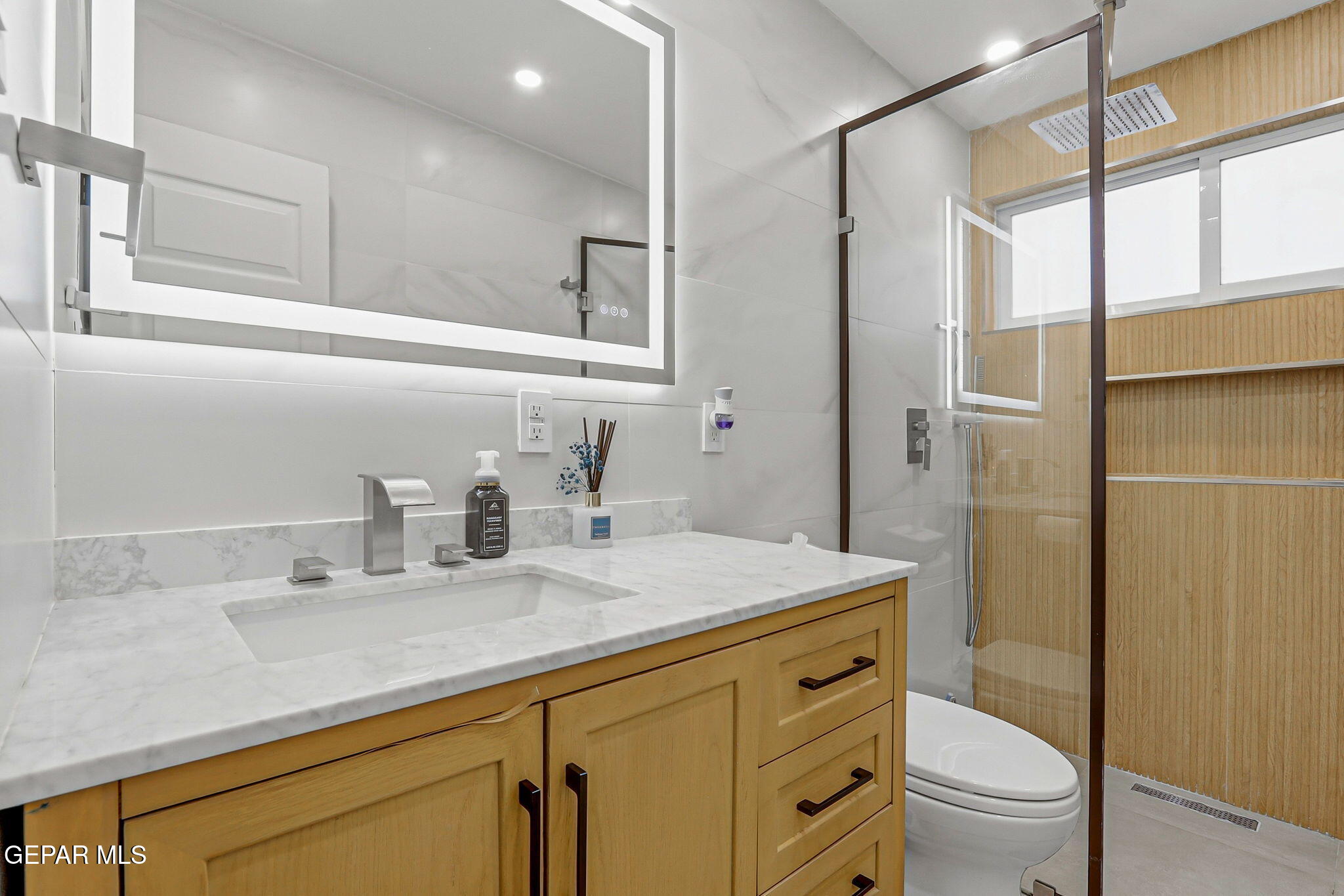 5240 Blue Ridge Drive El Paso, TX 79904 - Photo 27 of 37 a bathroom with a granite countertop sink toilet and shower