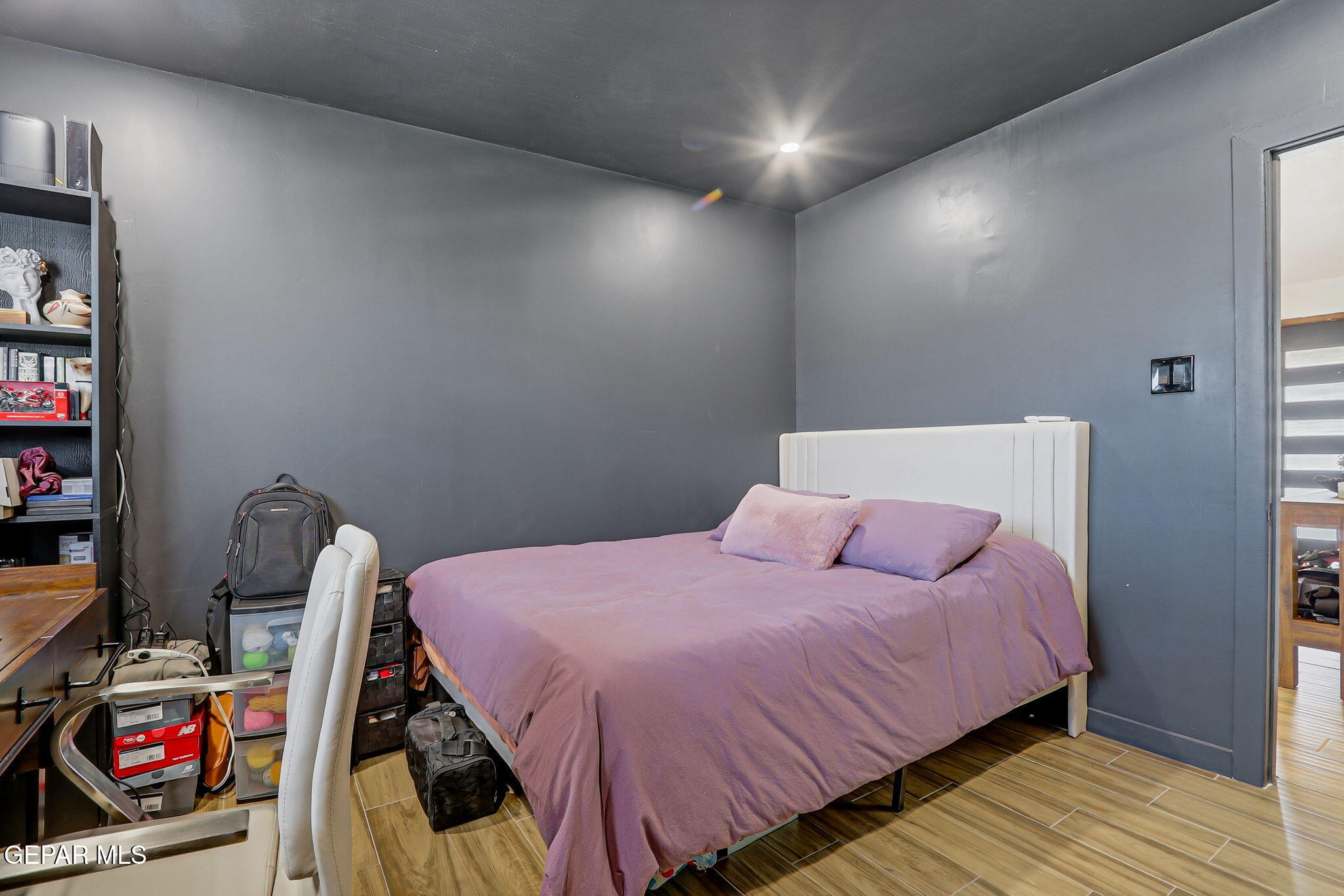 5240 Blue Ridge Drive El Paso, TX 79904 - Photo 31 of 37 a bedroom with a bed and a wooden floor