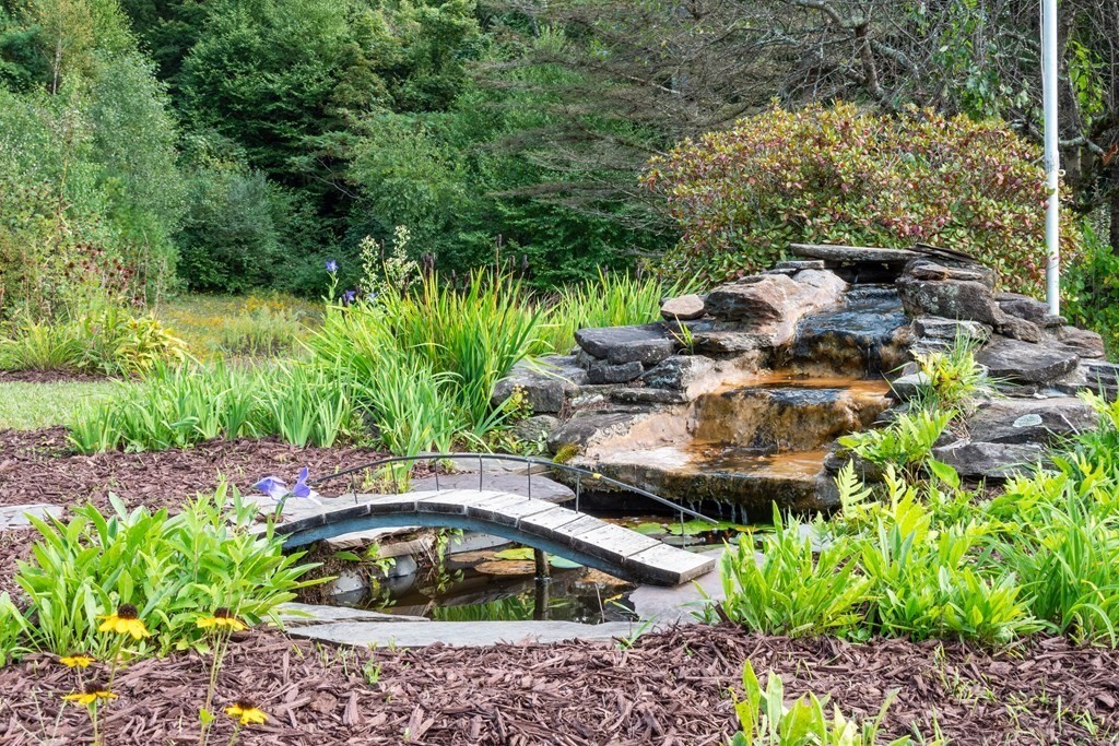 155 Worthington Road Huntington, MA 01050 - Photo 14 of 40 a view of a garden with a bench