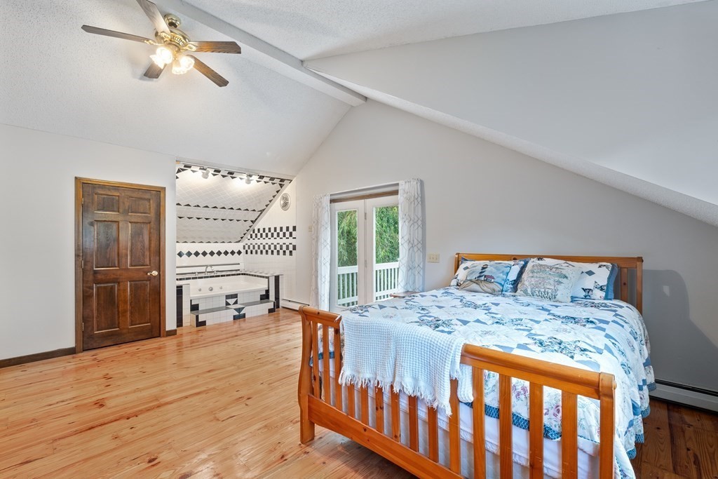 155 Worthington Road Huntington, MA 01050 - Photo 21 of 40 a bedroom with a bed and a table