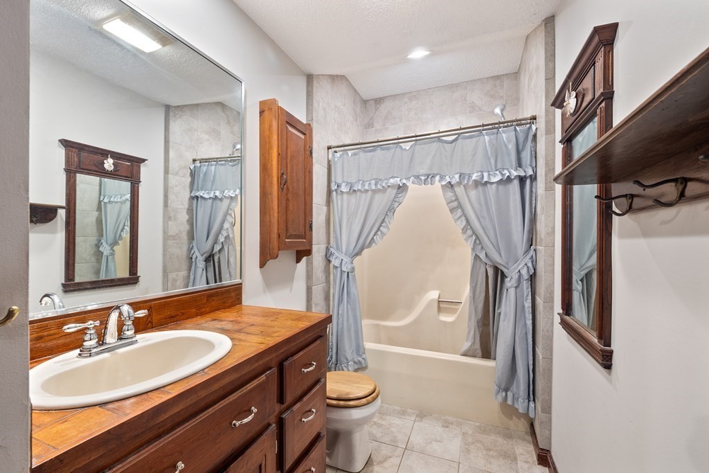 155 Worthington Road Huntington, MA 01050 - Photo 25 of 40 a bathroom with a granite countertop sink toilet and shower