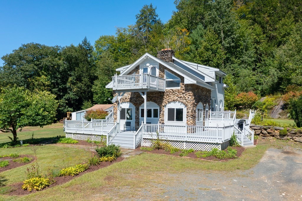 155 Worthington Road Huntington, MA 01050 - Photo 8 of 40 a front view of a house with a yard table and chairs