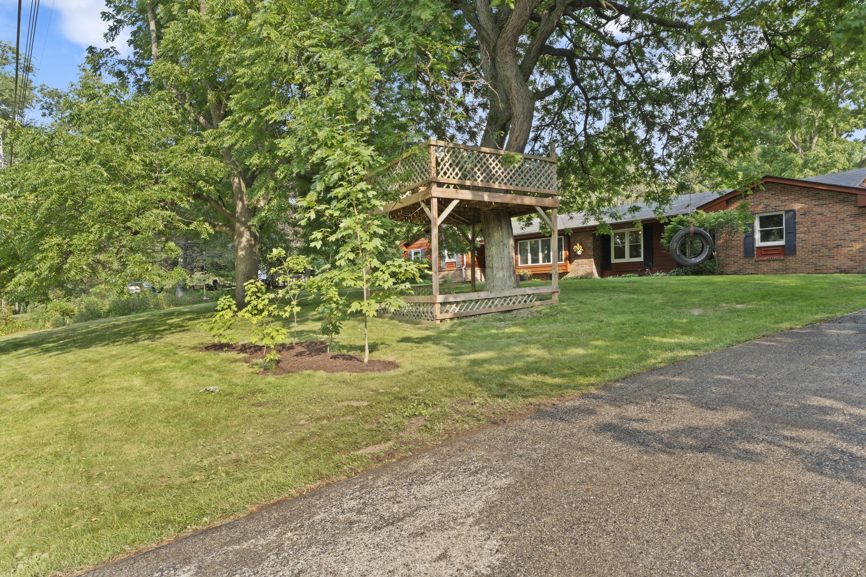 N8093 Lakeview Road Oconomowoc, WI 53066 - Photo 2 of 44 Large front yard with tree house included!
