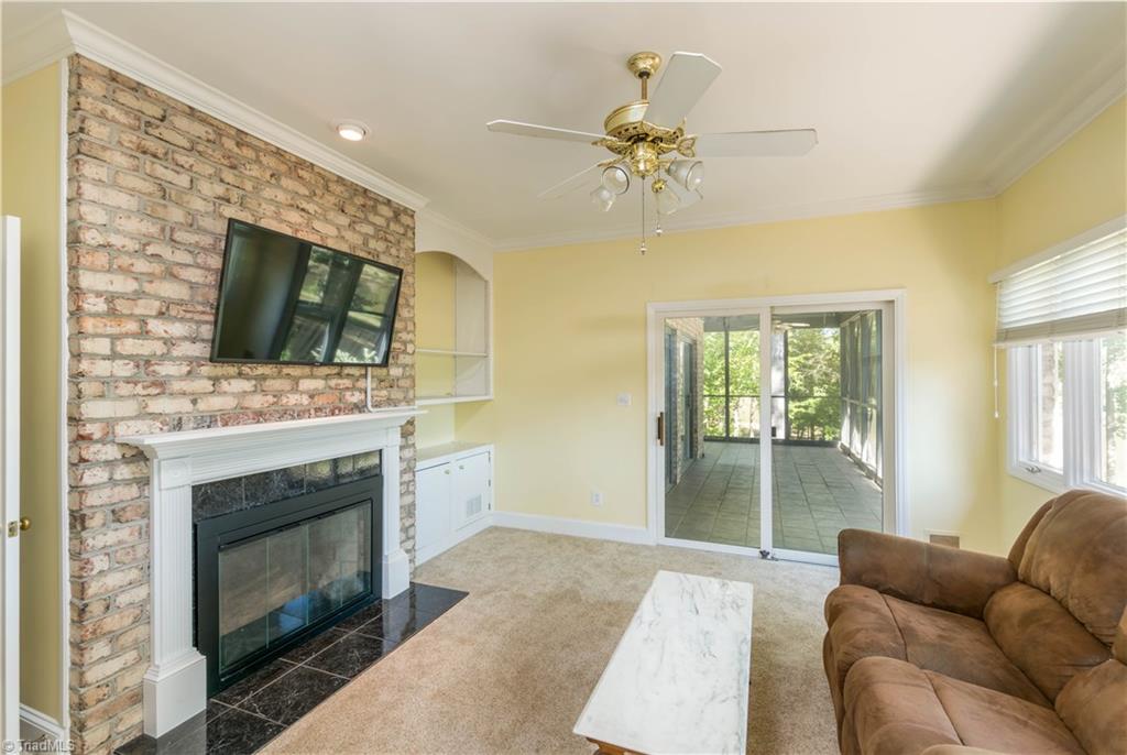 2012 River Road Stoneville, NC 27048 - Photo 10 of 30 Den with fireplace can be opened to the great room or the large screened porch off the master bedroom wing.