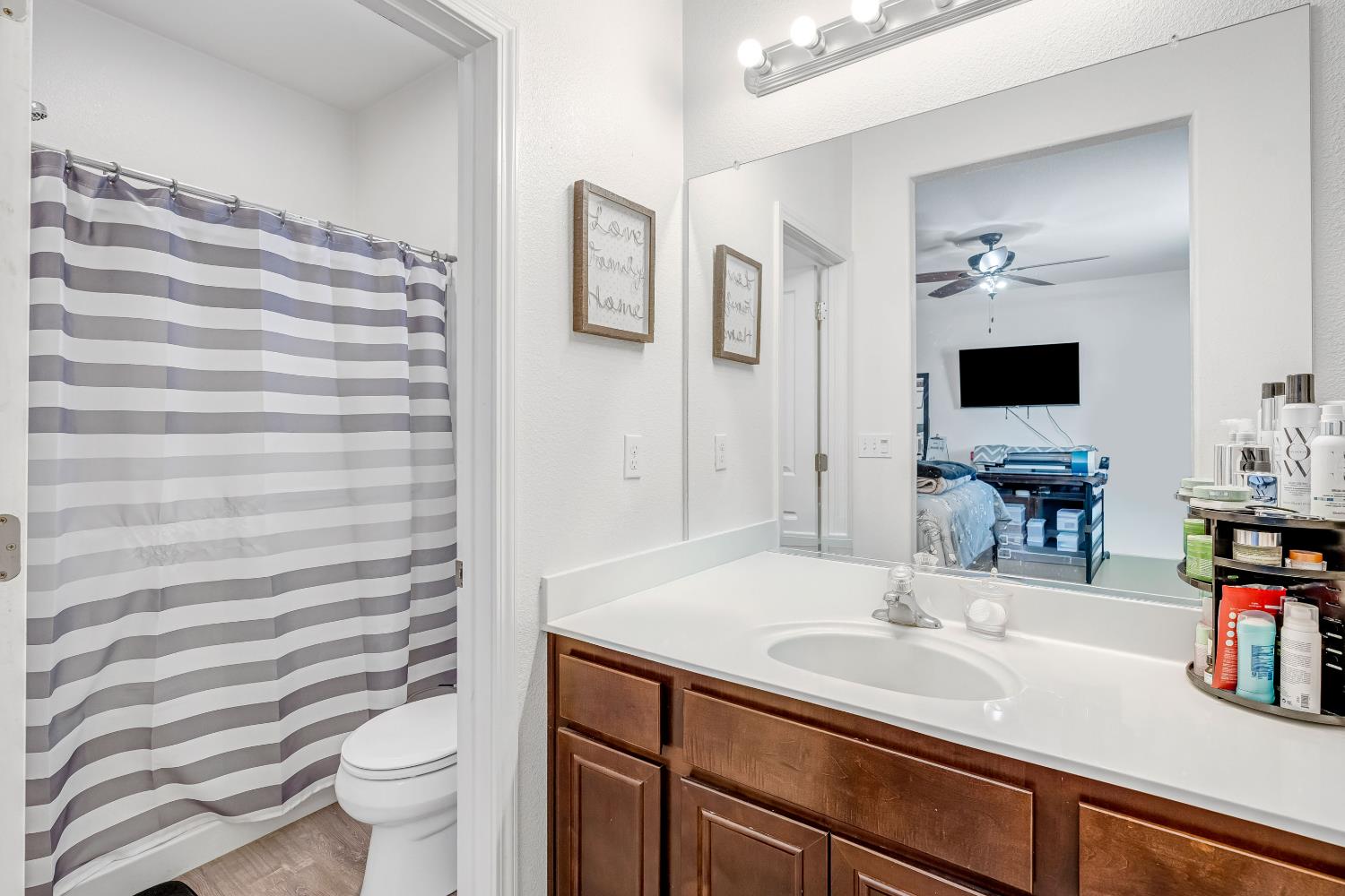 1981 Dunbar Way Dinuba, CA 93618 - Photo 11 of 12 a bathroom with a sink toilet double vanity and shower