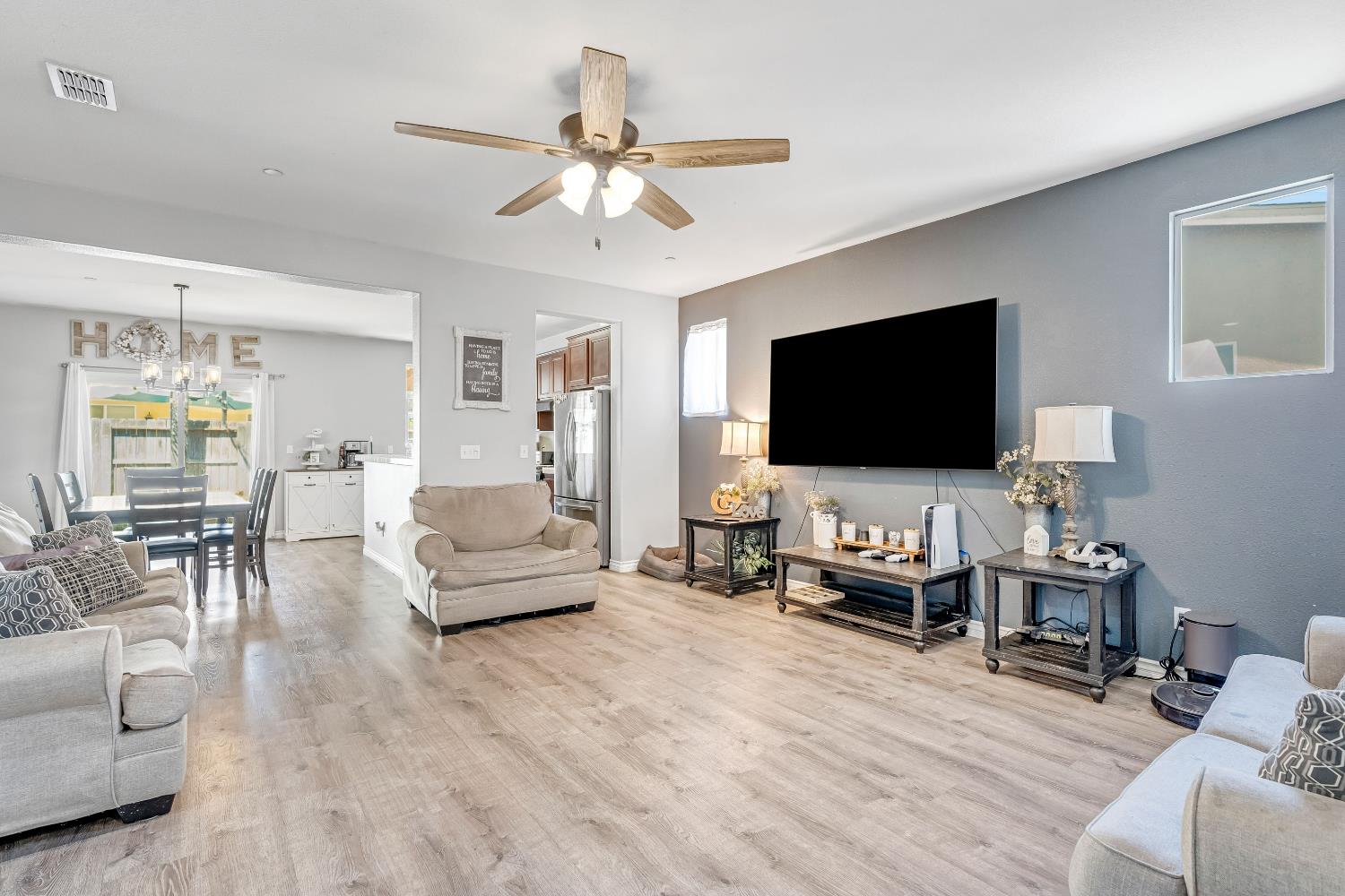 1981 Dunbar Way Dinuba, CA 93618 - Photo 2 of 12 a living room with furniture and a flat screen tv