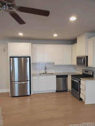a kitchen with granite countertop stainless steel appliances and wooden cabinets