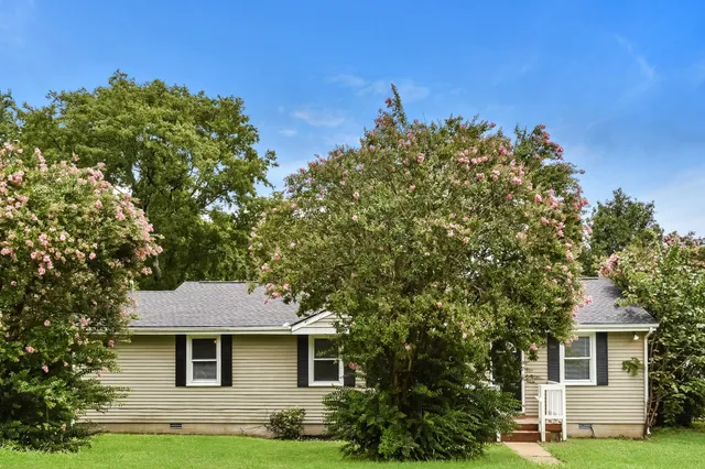a front view of a house with a garden