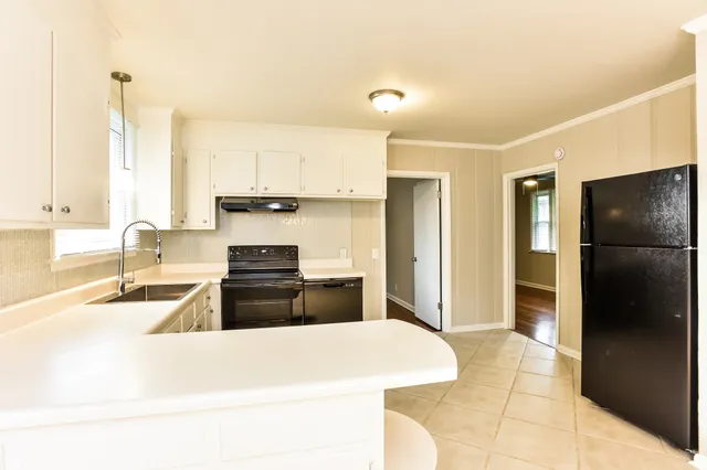 a kitchen with a refrigerator and a sink