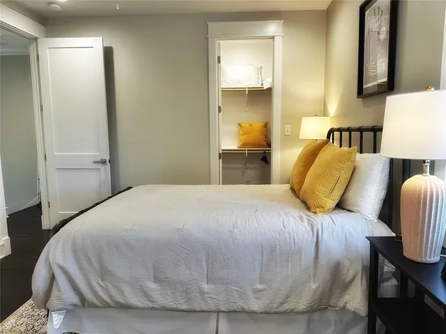 a bedroom with a bed and a lamp