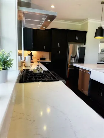 a kitchen with sink and refrigerator