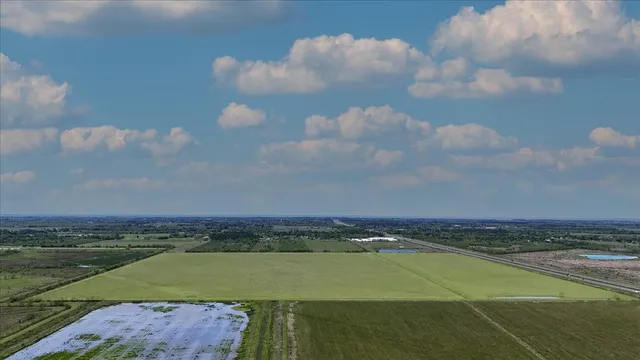 a view of a lake in the middle of a field