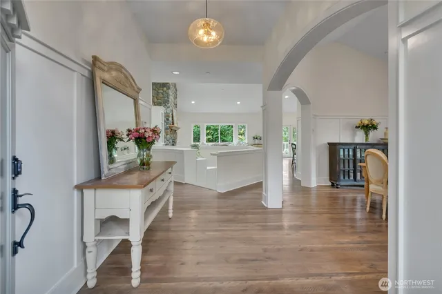 a kitchen with furniture and a wooden floor