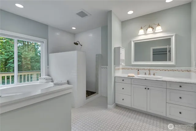 a bathroom with double vanity and a mirror