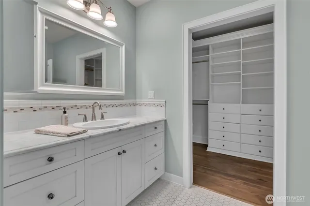 a bathroom with a sink double vanity and a mirror