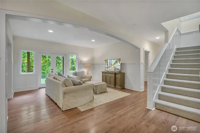 a living room with furniture and a wooden floor