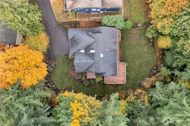 an aerial view of a house with a garden and yard