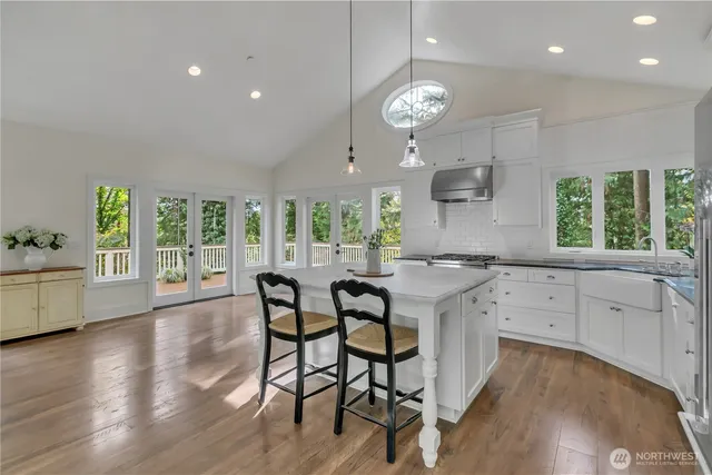 a kitchen with a table chairs sink and cabinets
