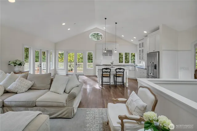 a living room with furniture kitchen and a large window