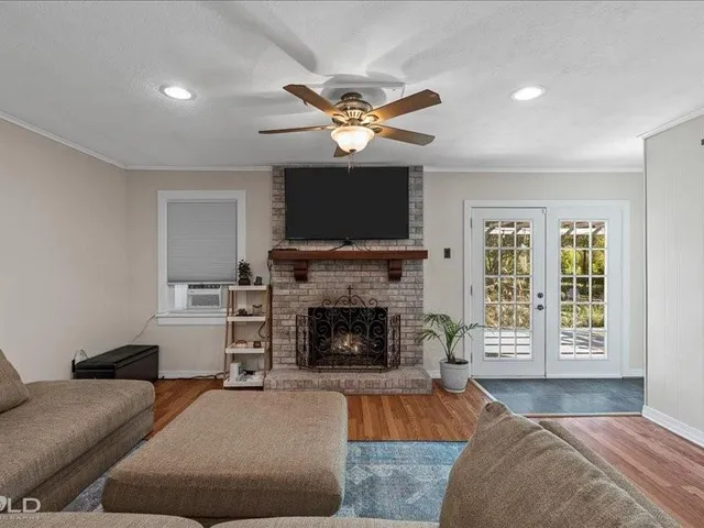 a living room with furniture a fireplace and a flat screen tv