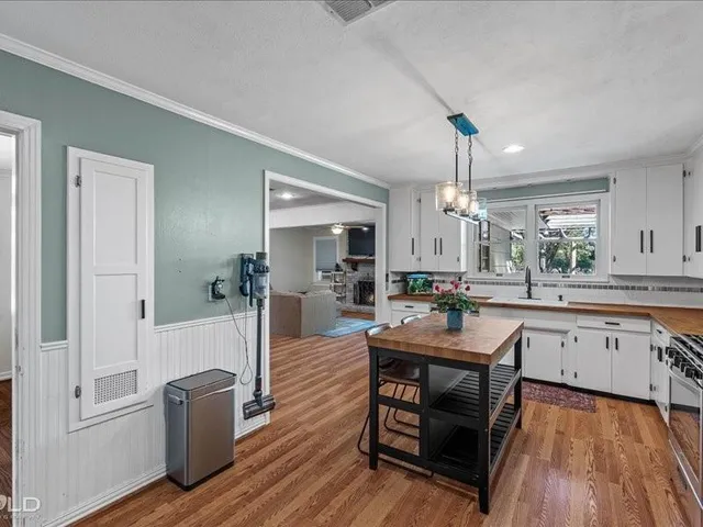 a kitchen with counter top space a sink appliances and cabinets