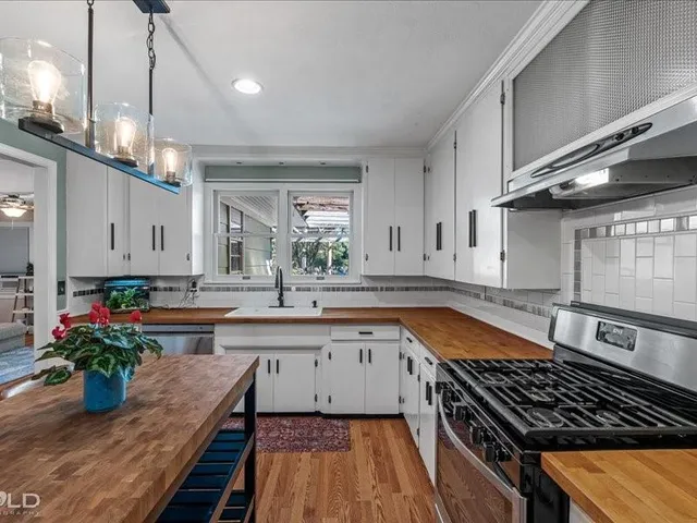 a kitchen with lots of counter top space and wooden floor