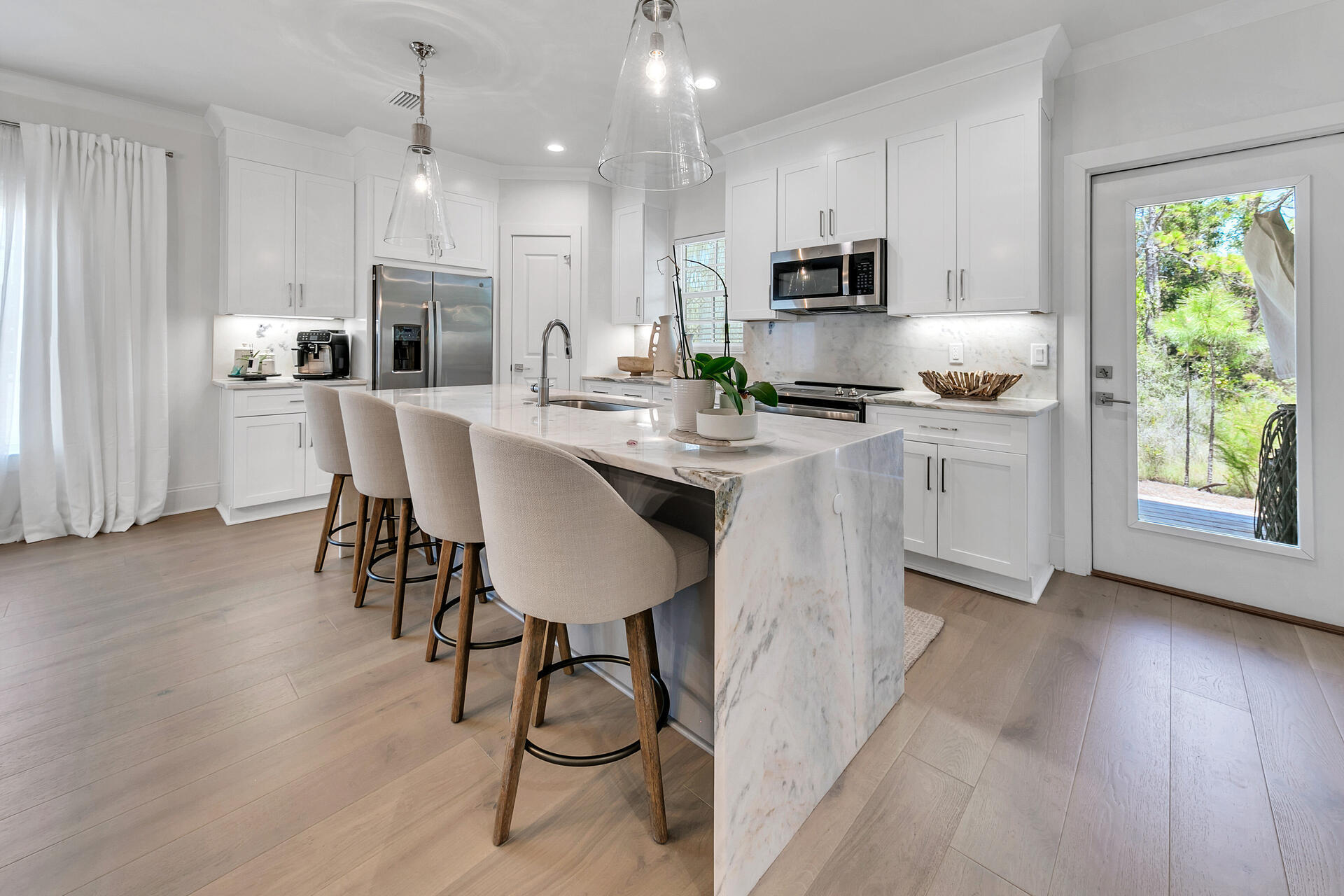 106 Heron's Crossing Santa Rosa Beach, FL 32459 - Photo 15 of 65 a kitchen with stainless steel appliances granite countertop a stove a sink a microwave a refrigerator and white cabinets with wooden floor