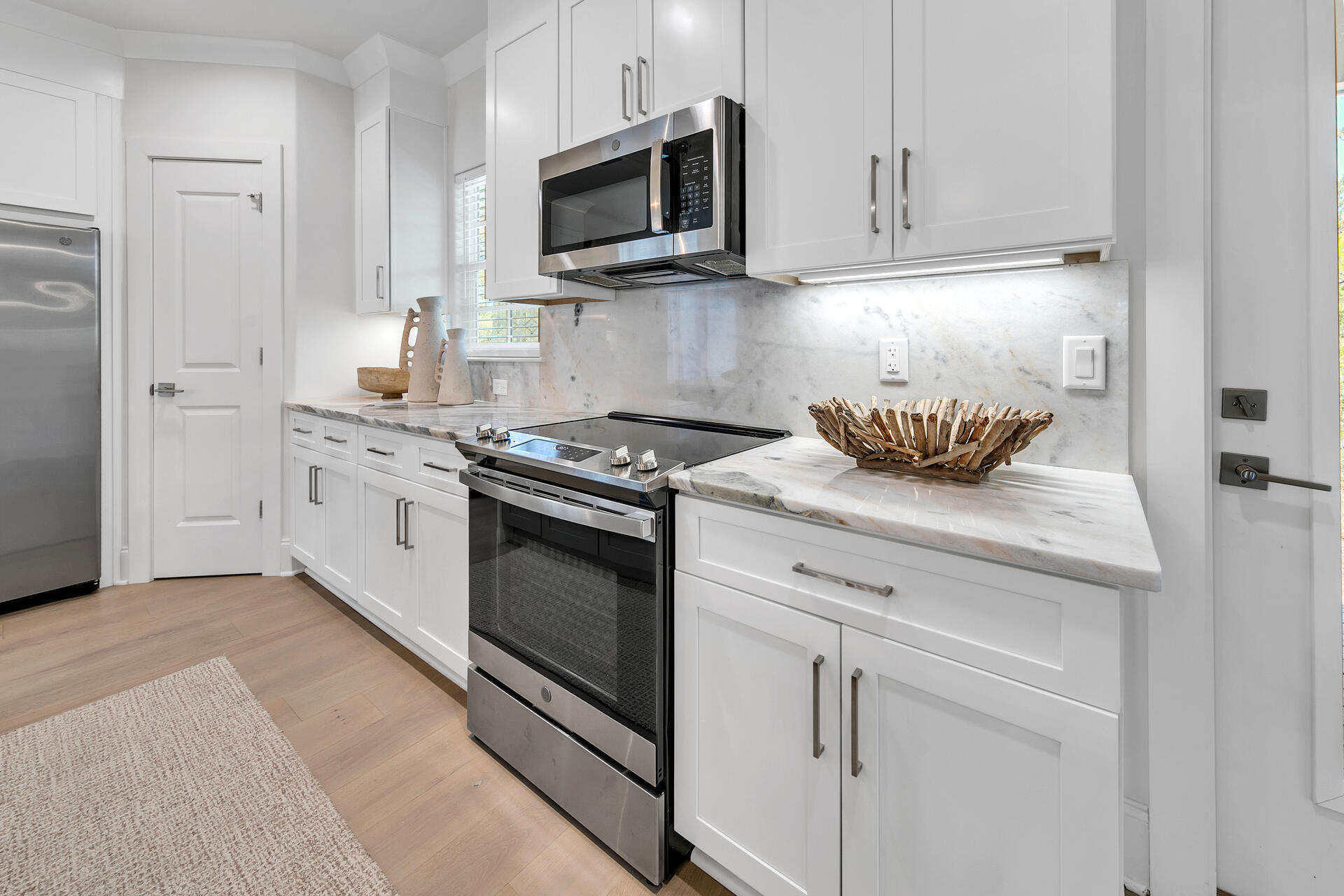 106 Heron's Crossing Santa Rosa Beach, FL 32459 - Photo 16 of 65 a kitchen with stainless steel appliances granite countertop white cabinets a stove a sink and dishwasher