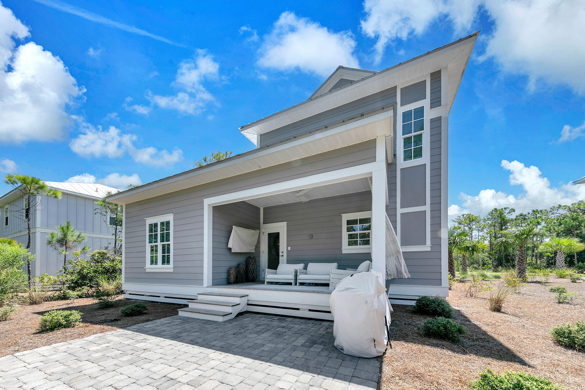 106 Heron's Crossing Santa Rosa Beach, FL 32459 - Photo 49 of 65 a front view of a house with garden and plants