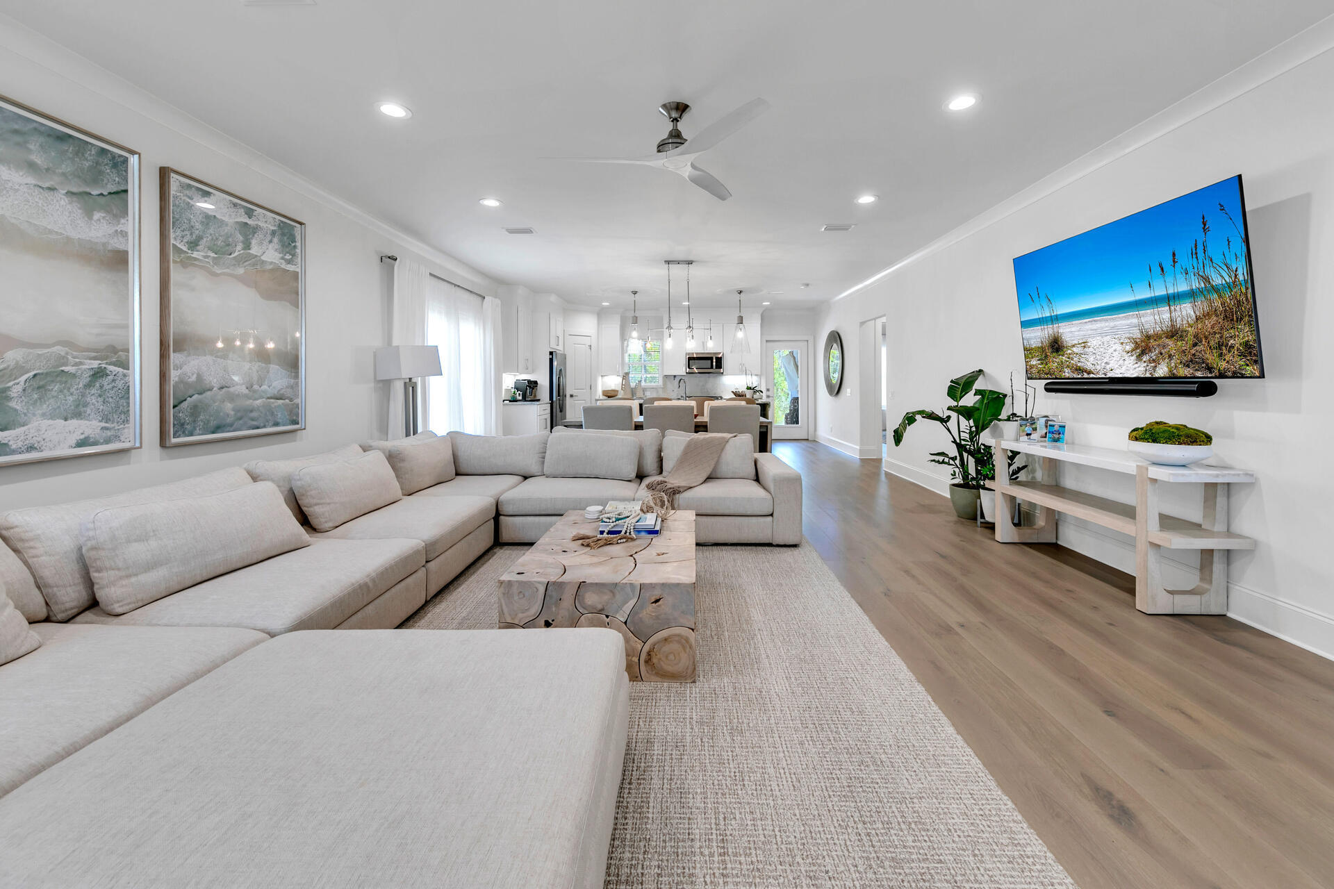 106 Heron's Crossing Santa Rosa Beach, FL 32459 - Photo 7 of 65 a living room with furniture flat screen tv and wooden floor